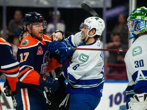 Abbotsford Canucks defenseman Ashton Sautner battles with Bakersfield Condors forward Brad Malone during Game 2 of their best-of-three opening round AHL playoff series.