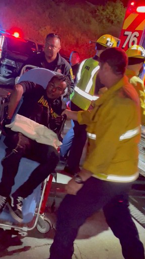 A man is transported into an ambulance after comedian Dave Chappelle was attacked on stage during a stand-up Netflix show at the Hollywood Bowl, in Los Angeles, US, May 3, 2022, in this still image obtained from a social media video.  Theodore Nwajei/via REUTERS