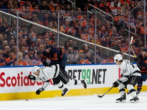Edmonton Oilers' Zach Hyman (18) hits LA Kings' Alexander Edler (2) during first period NHL action in Game 2 of their first round Stanley Cup playoff series in Edmonton, on Wednesday, May 4, 2022.