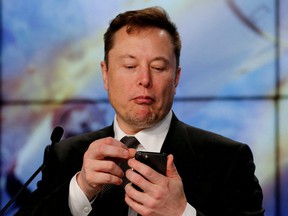 Elon Musk looks at his mobile phone in Cape Canaveral, Florida, January 19, 2020.