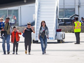 Roman and Olha Koval, and their three sons, Oleh, 11, Taras, 7, and Yurii, 3, are among 28 people fleeing the war from Ukraine, arriving at a terminal at Toronto Pearson International Airport on a plane from Poland, operated by Samaritan's Purse Canada on Sunday May 15, 2022.