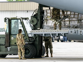 Airmen unload pallets from the cargo bay of a US Air Force C-17 carrying 78,000 lbs of Nestle baby formula from Europe at Indianapolis Airport on May 22, 2022 in Indianapolis, Indiana.