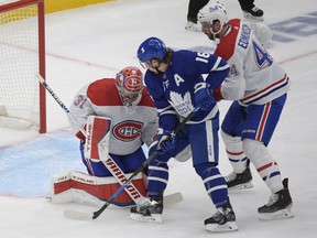 Montreal Canadiens goalie Carey Price makes a save as defenseman Joel Edmundson covers Toronto Maple Leafs forward Mitch Marner in Game 7 of the first round of the 2021 Stanley Cup playoffs.  Marner was held scoreless for the duration of the series.