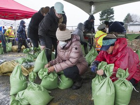 Volunteers fill sandbags in Abbotsford during the floods in November.
