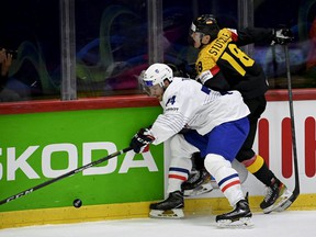 France's defender Thomas Thiry (left) and Germany's forward Tim Stuetzle vie for the puck during the IIHF Ice Hockey World Championships 1st Round group A match between France and Germany at the Helsinki ice Hall in Helsinki, Finland, on May 16, 2022.