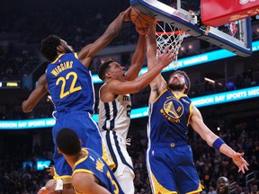Memphis Grizzlies guard Desmond Bane, center, has his shot blocked by Golden State Warriors forward Andrew Wiggins, left, and guard Klay Thompson in the second quarter during Game 6 of the second round for the 2022 NBA playoffs at Chase Center in San Francisco, Calif ., May 13, 2022.