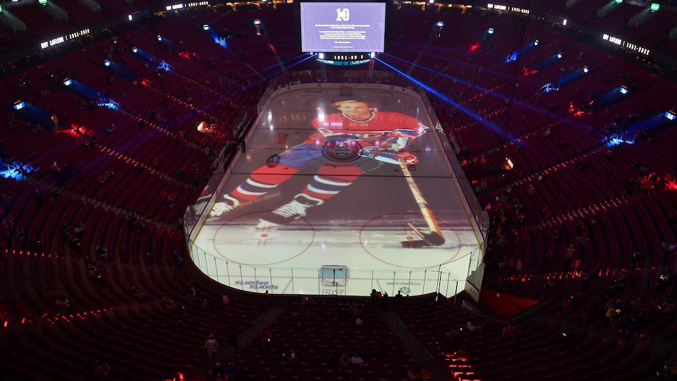 An image of Guy Lafleur is projected onto the Bell Center ice rink.