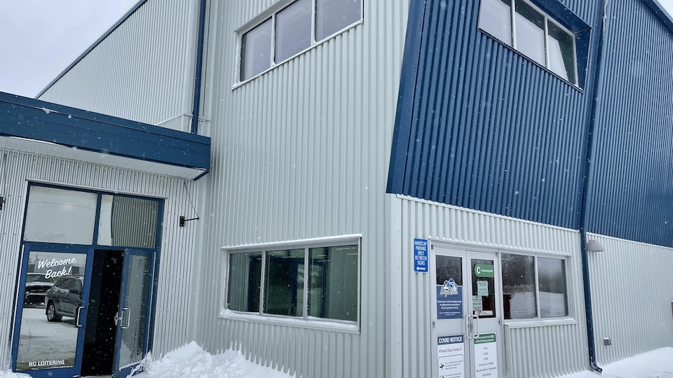 A blue building under the snow.
