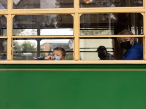 A young rider looks out the window of the Edmonton Radial Railway Society's High Level Bridge Streetcar on a trip through Old Strathcona in Edmonton, on Sunday, Aug. 8, 2021. Photo by Ian Kucerak