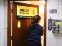 A woman enters Amnesty International's Hong Kong office, after its closure announcement citing China's national security law, in Hong Kong, China October 25, 2021. REUTERS/Tyrone Siu 