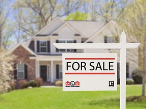 Blank Real Estate Sign in Front of Beautiful New House.