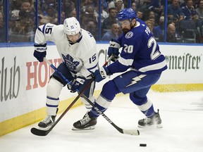 Alexander Kerfoot, here battling for the puck against Lightning's Nick Paul, is believed, at some point, to have played in 11 of 12 possible forward slots for the Leafs this season.