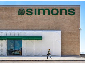 A shopper leaves the 16th Simons store, located at Fairview Pointe-Claire shopping center, on Thursday.