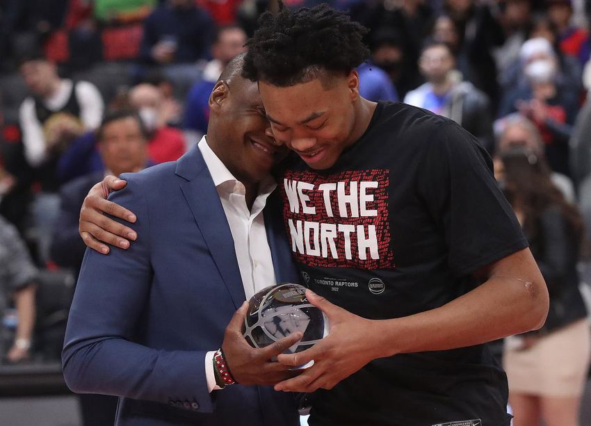 Raptors president Masai Ujiri hugs Scottie Barnes after handing him the NBA rookie of the year award.