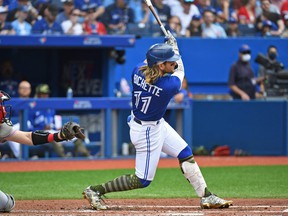 Toronto Blue Jays shortstop Bo Bichette (11) hits a solo home run in the fourth inning against the Cincinnati Reds at Rogers Center.