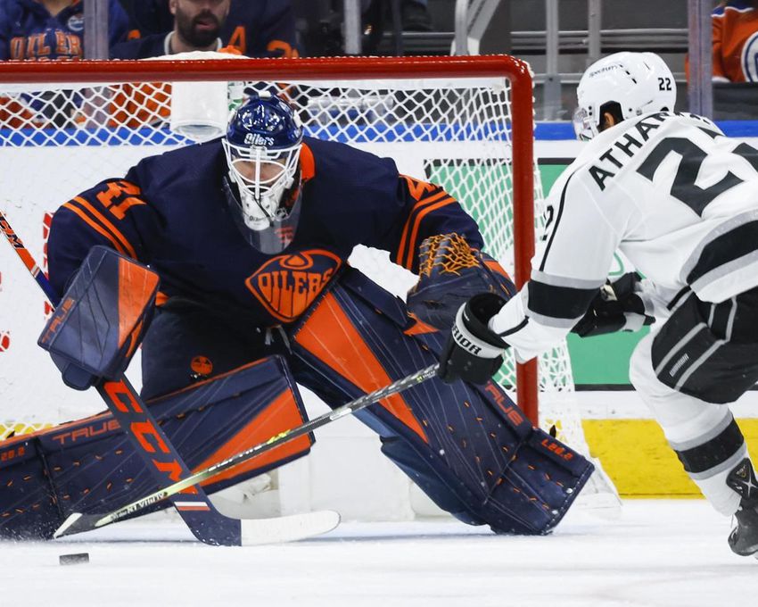 Los Angeles Kings center Andreas Athanasiou, right, attempts a shot at Edmonton Oilers goalie Mike Smith during second period NHL playoff hockey action in Edmonton on Saturday, May 14 of 2022.