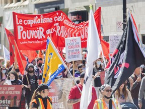 People take part in a May Day demonstration in Montreal, Sunday, May 1, 2022.