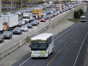 Motorists line up to access the Champlain Bridge as buses enter the reserved lane during the morning rush hour in Montreal on Tuesday October 24, 2017.