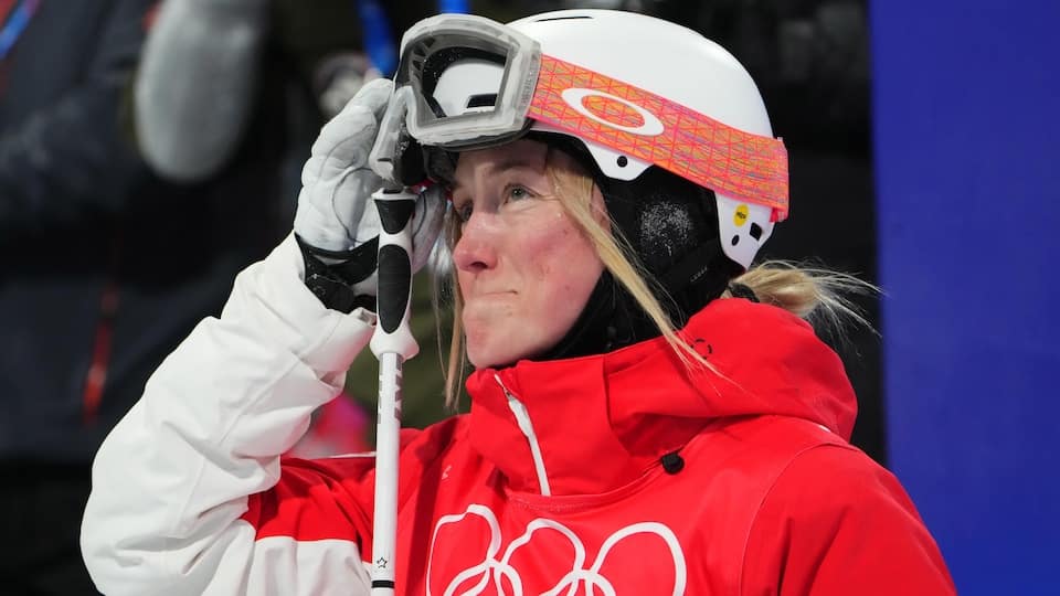 Justine Dufour-Lapointe raises her ski goggles and is moved.