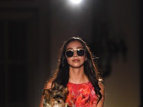 Kennedy McGonigal of Images Models borrowed Diane Buchanan's Money Penny pet to help display her Marc Cain dress and glasses from the Vision Parlor at the Haute Dawg gala and fashion show at the Fairmont Hotel Macdonald.  Supplied.