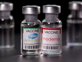 Vials with Pfizer-BioNTech and Modern coronavirus disease (COVID-19) vaccine labels.