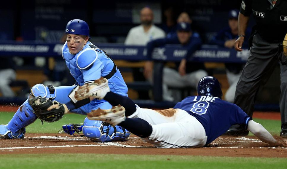Tampa Bay's Brandon Lowe slides into home under the tag of Jays catcher Zack Collins in the second inning Friday.