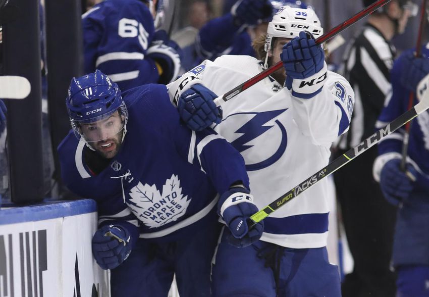 Tampa's Brandon Hagel rides Colin Blackwell of the Leafs into the boards in Wednesday's Game 2 of their first-round playoff series at Scotiabank Arena.