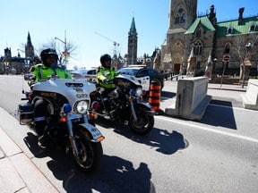 Police patrol Wellington Street in Ottawa before the arrival of the 
