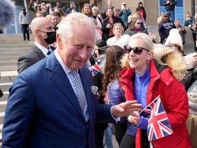 Prince Charles greets a well-wisher as he arrives in St. John's, Newfoundland and Labrador, for a three-day Canadian tour on May 17, 2022.