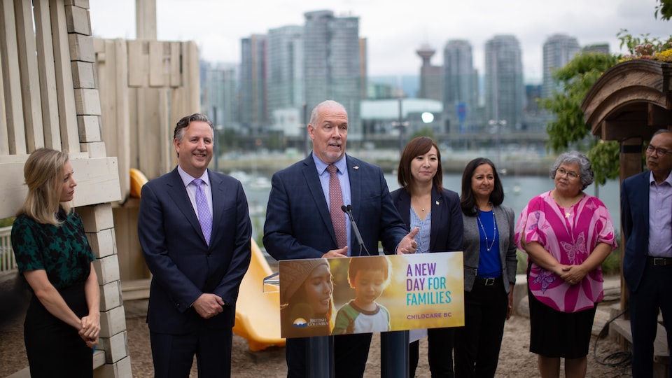 The Premier of British Columbia flanked by the Mayor of Vancouver and the Minister of State for Early Childhood at an announcement in Vancouver, July 4, 2019.