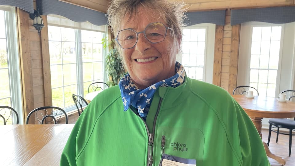 Denise Lapointe wears a green jacket and a blue scarf. 