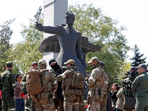 Service members of pro-Russian troops during a ceremony, marking the 77th anniversary of the victory over Nazi Germany in the Second World War, in Mariupol, Ukraine May 9, 2022.