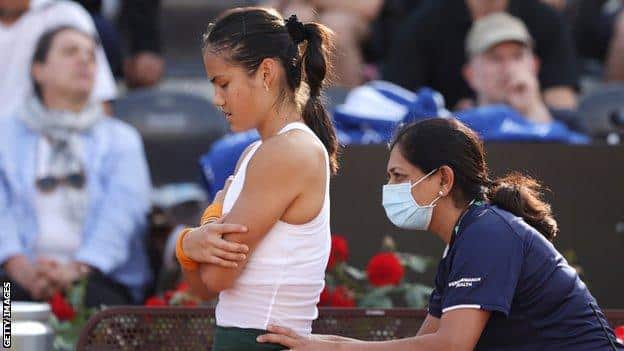 Emma Raducanu receives treatment during her Italian Open match against Bianca Andreescu
