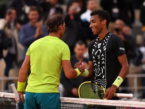 Rafael Nadal of Spain shakes hands with Felix Auger-Aliassime of Canada following the Men's Singles Fourth Round match on Day 8 of The 2022 French Open at Roland Garros on May 29, 2022 in Paris.