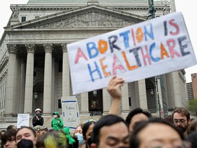 People protest after the leak of a draft majority opinion written by US Supreme Court Justice Samuel Alito, preparing for the court's majority to reverse the landmark decision on abortion rights Roe v.  Wade, in New York City on May 3, 2022.