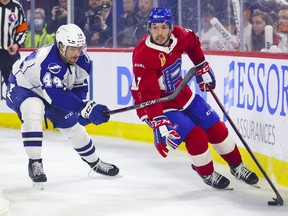 Laval Rocket's Louie Belpedio protects the puck from Syracuse Crunch's Frank Hora during the first period of a playoff game at the Place Bell Sports Complex in Laval on Saturday, May 14, 2022.