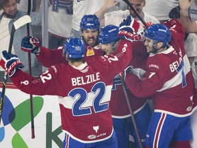 Rocket players celebrate a first-period goal by teammate Danick Martel (18) during AHL playoff action against Syracuse Crunch in Laval Thursday night.