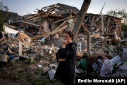 Anna Shevchenko, 35, reacts outside her bombed-out house in Irpin, near kyiv, Tuesday, May 3, 2022. (Emilio Morenatti/AP)