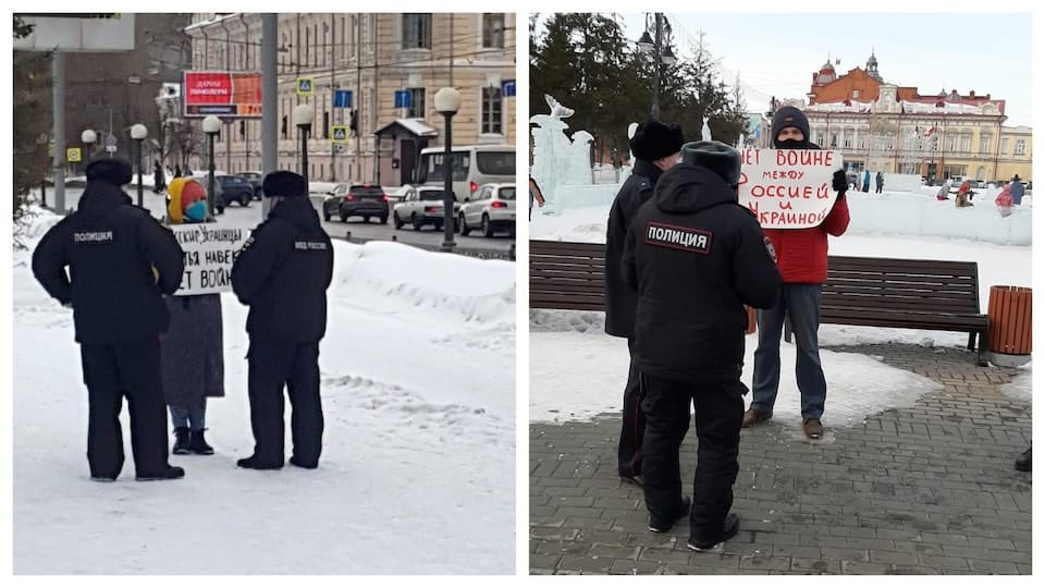 Anastasia Ryabkova and her husband Vladimi Ryabkov surrounded by police as they demonstrate with anti-war placards.