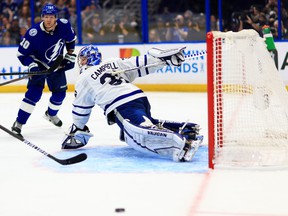 Maple Leafs goaie Jack Campbell stops a shot from Lightning's Corey Perry in Tampa on Sunday night.