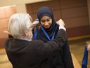 Arsala Basit, 11, receives the silver medal from Bill Baylis, president of Canada South Science City, for her project Awesome Air at the Windsor Regional Science, Technology and Engineering Fair at the University of Windsor, Sunday, April 2, 2017.