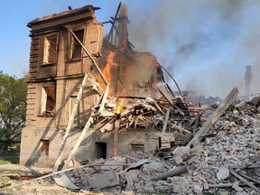 Debris is seen next to a partially collapsed building, after a school building was hit as a result of shelling, in Bilohorivka village, Luhansk, Ukraine, on May 8, 2022.