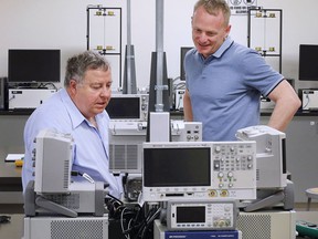 'Putting us on the world stage.'  Peter Frise, left, director of the University of Windsor's Center for Automotive Research and Education, and Faculty of Engineering dean Bill Van Heyst are shown in a lab at the school on Tuesday, May 3, 2022.