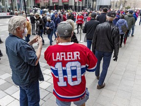 Hockey fans line up for the Guy Lafleur public visitation at the Bell Center on Monday.