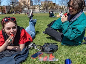 “This is my first summer here and I'm really happy that winter is over," said Clelia Aubigny, left, at Montreal's Jeanne-Mance Park on Friday.  Manon Morin was less enthusiastic about the rise in temperature.
