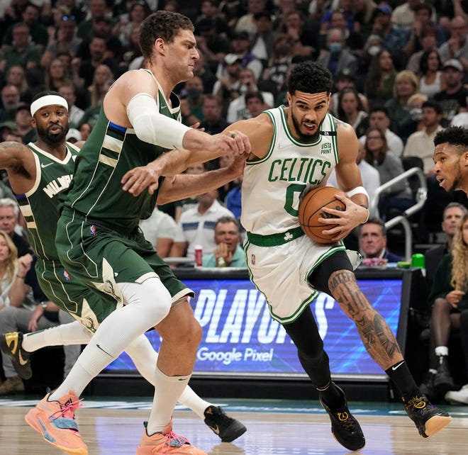 Celtics forward Jayson Tatum tries to get past Bucks center Brook Lopez in the first quarter.