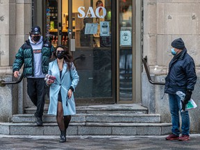 Two customers leave the SAQ store in Old Old Montreal.
