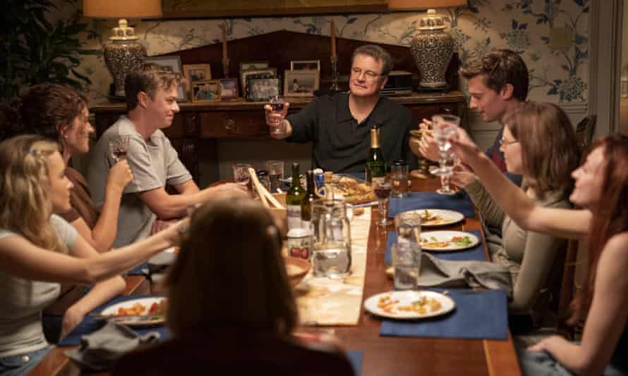 Peterson (Firth) toasts his family around the table