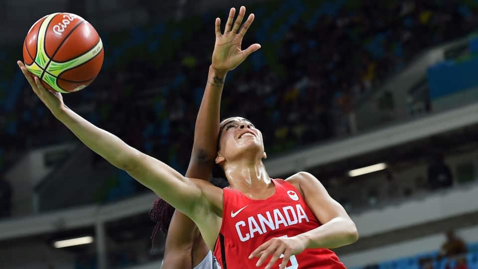 Kia Nurse catches the ball past Valeriane Ayayi during a match between France and Canada. 