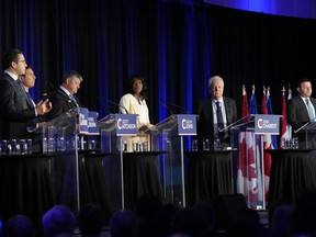 Conservative leadership hopefuls Pierre Poilievre, from left, Patrick Brown, Scott Aitchison, Leslyn Lewis, Jean Charest and Roman Baber participate in the Conservative Party of Canada's French-language leadership debate in Laval, Quebec, on Wednesday, May 25. May 2022.